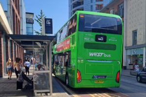 A West bus stopped at a bus shelter in Broadmead next to Cabot Circus