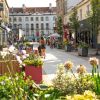 View of pedestrianised section of Princess Victoria Street with raised flower beds and seating outside cafes