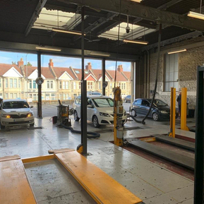 A MOT garage with several carsin it