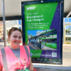 travel advisor stood at a bus stop in front of a Broadmead bus changes sign