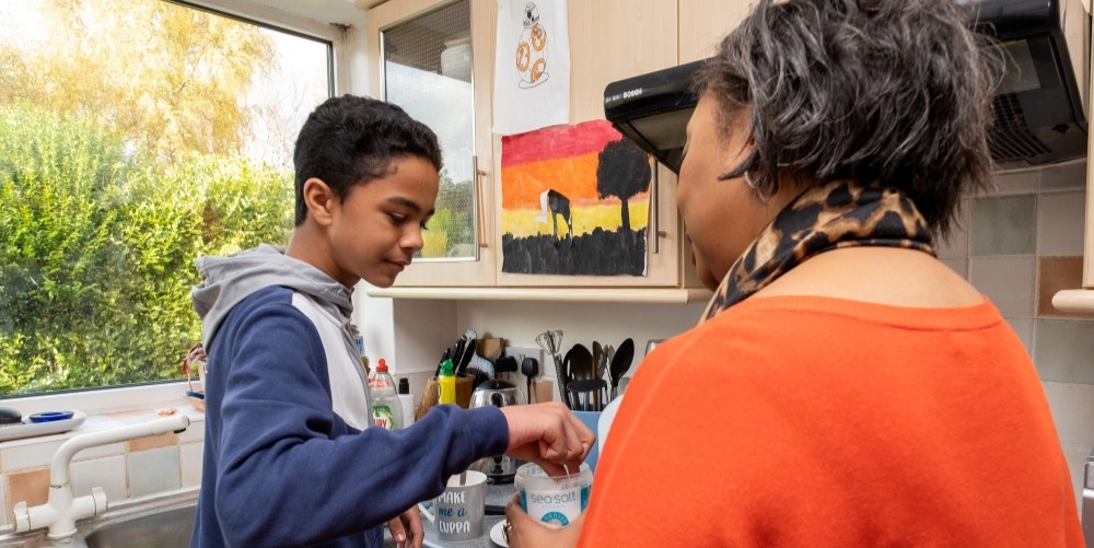 Woman and teenage boy in kitchen