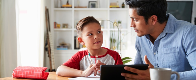 A father helping his son with homework.