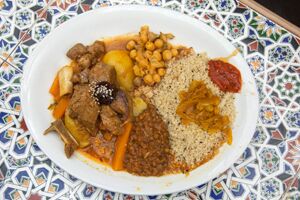 A plate with meat, rice and chickpeas